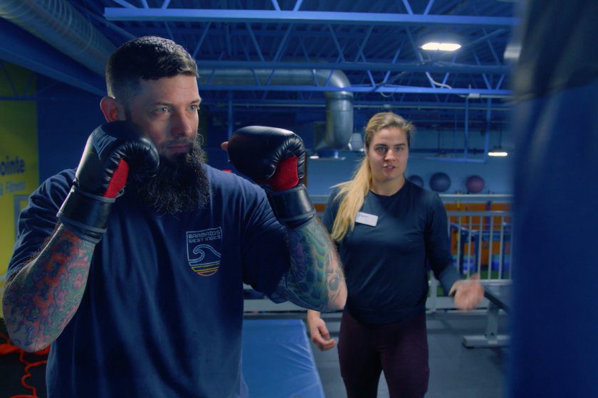 A gym member does kickboxing training with a trainer during a personal training session at an Atlantic Highlands gym